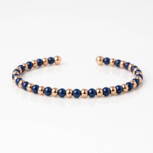 Pulsera bolitas oro titanio y cerámica azul
