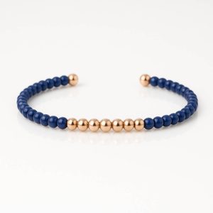 Pulsera bolitas oro titanio y cerámica azul